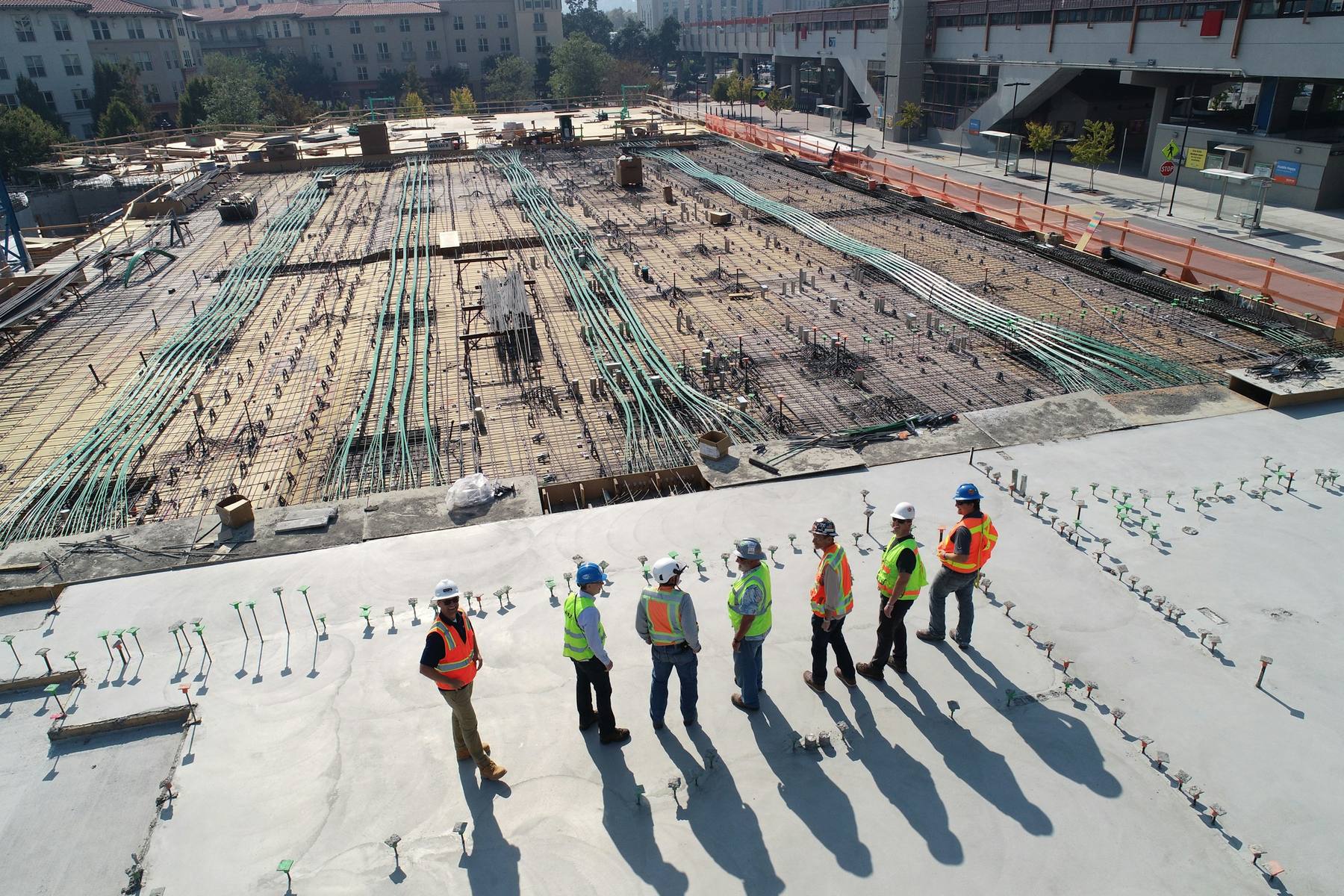 Crew in hard hats and hi-vis vests on a job site